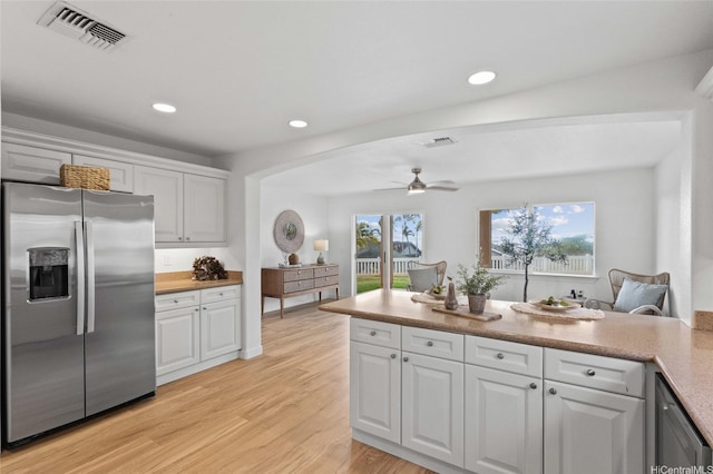 92-6012 Kohi St, Kapolei, HI 96707 - kitchen with stainless steel refrigerator with ice dispenser, a ceiling fan, white cabinets, light wood-style flooring, and open floor plan
