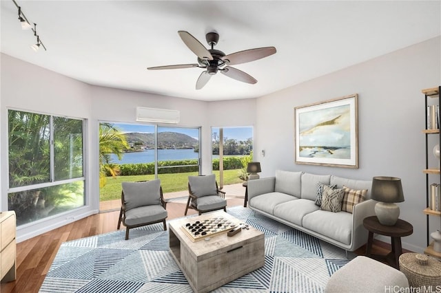 interior space featuring a water view, ceiling fan, and a wall mounted AC