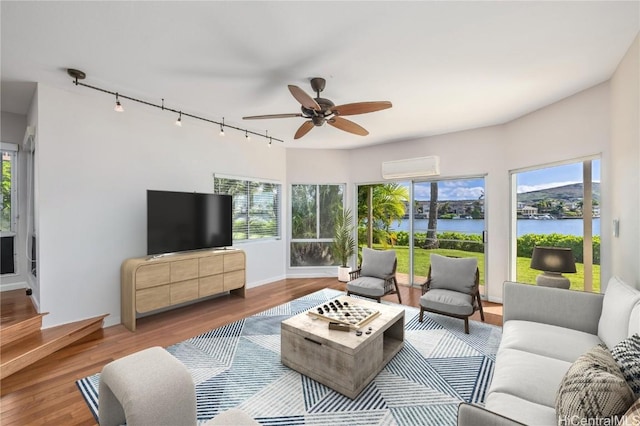 sunroom / solarium featuring a wealth of natural light, rail lighting, and ceiling fan