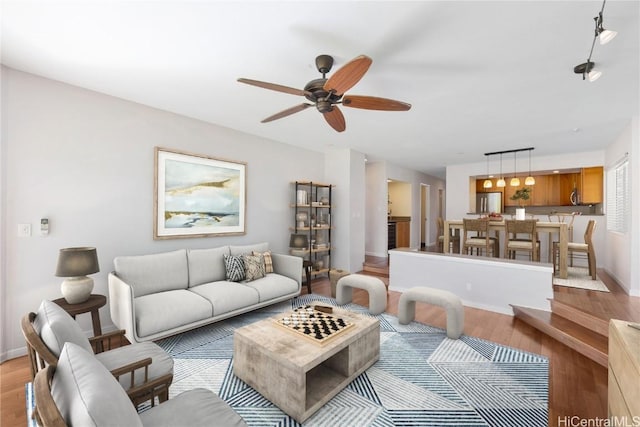 living room featuring light hardwood / wood-style floors and ceiling fan