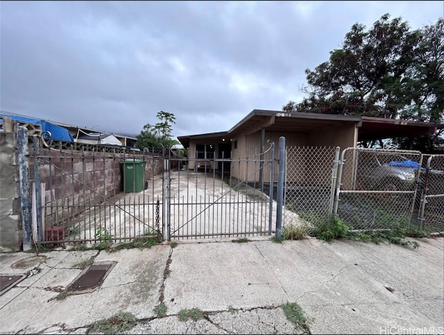 view of gate featuring a carport