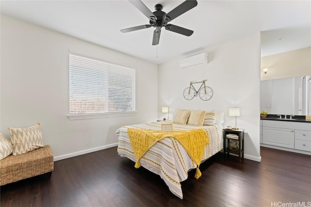 bedroom with dark wood finished floors, a sink, ceiling fan, a wall mounted air conditioner, and baseboards