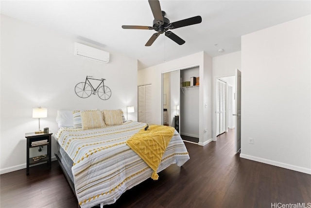 bedroom featuring a closet, a wall mounted air conditioner, wood finished floors, and baseboards