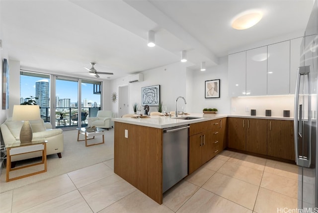 kitchen featuring white cabinetry, sink, stainless steel appliances, and kitchen peninsula