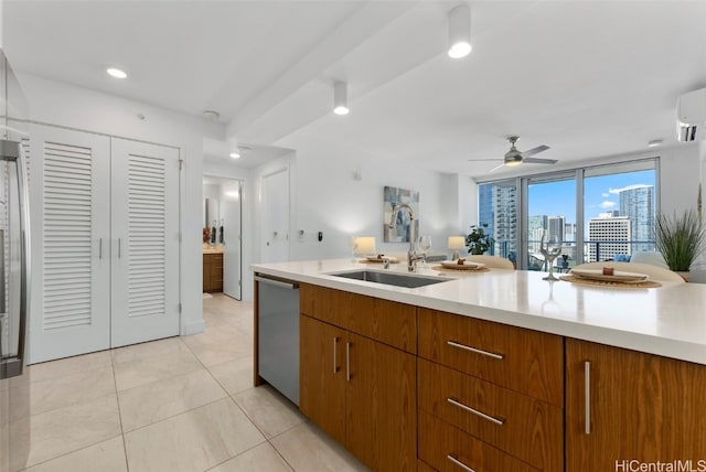 kitchen with sink, a wall mounted AC, light tile patterned floors, stainless steel dishwasher, and ceiling fan