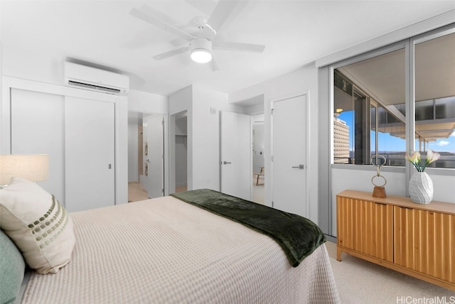 carpeted bedroom featuring ceiling fan, a wall mounted air conditioner, and two closets