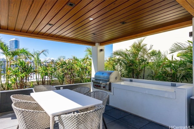 view of patio featuring area for grilling and a grill