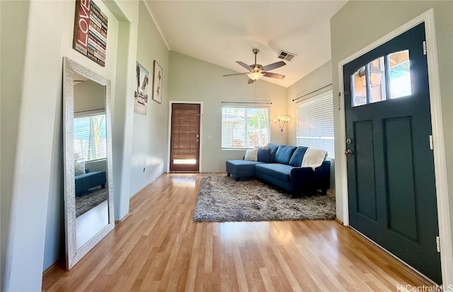 foyer featuring high vaulted ceiling, ceiling fan, and light wood-type flooring