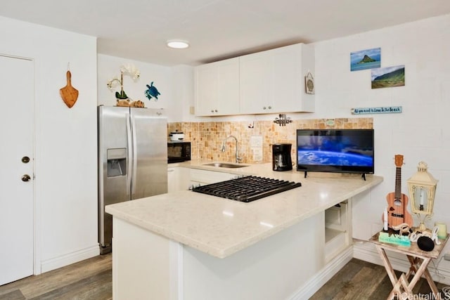 kitchen with sink, white cabinetry, dark hardwood / wood-style flooring, kitchen peninsula, and stainless steel appliances