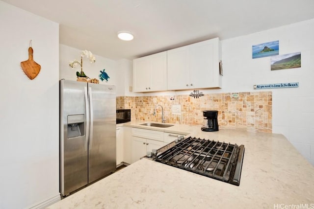 kitchen with stainless steel refrigerator with ice dispenser, sink, white cabinetry, tasteful backsplash, and range