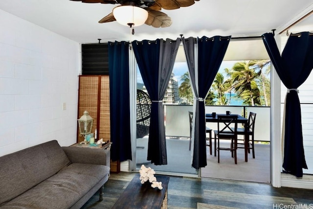 living room with ceiling fan and dark hardwood / wood-style flooring