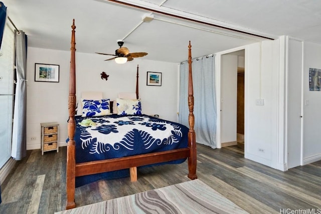 bedroom with ceiling fan and dark hardwood / wood-style floors