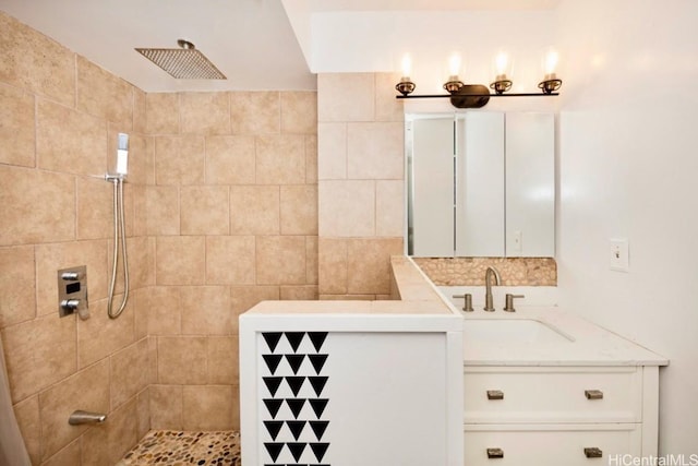 bathroom with vanity and a tile shower