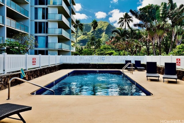 view of pool with a mountain view and a patio