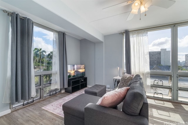 living room with ceiling fan and hardwood / wood-style floors