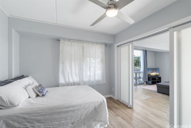 bedroom featuring light hardwood / wood-style floors and ceiling fan