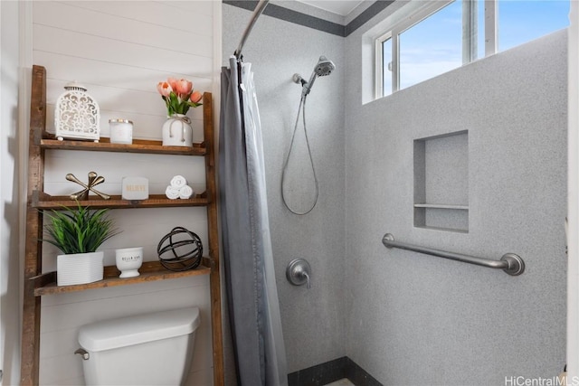 bathroom with a shower with curtain and toilet