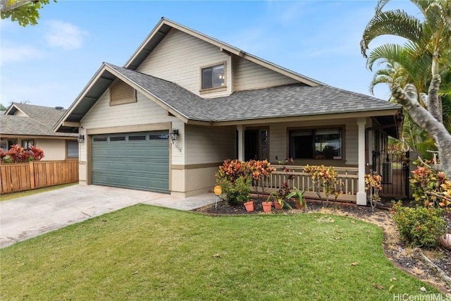 view of front of property featuring a garage, a front yard, and a porch