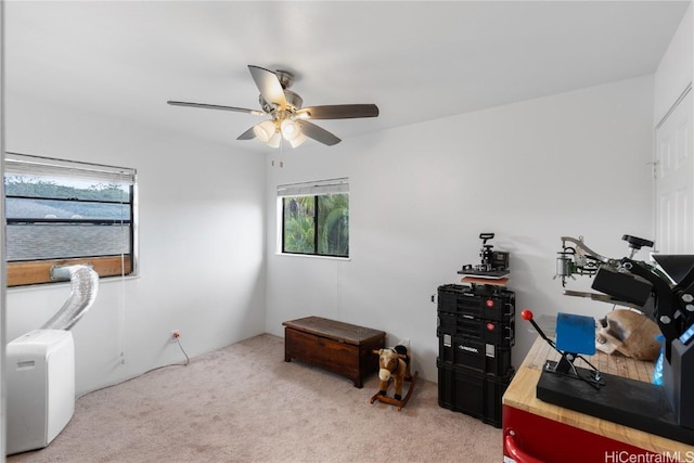 miscellaneous room featuring light colored carpet and ceiling fan