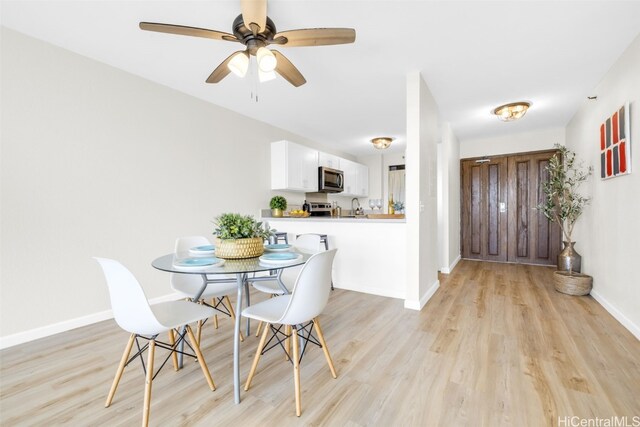 dining space featuring ceiling fan and light hardwood / wood-style flooring