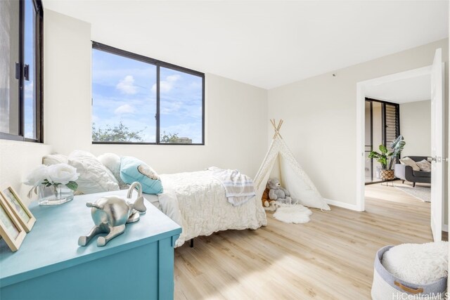 bedroom with light hardwood / wood-style floors