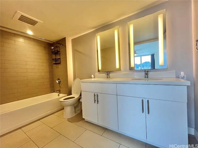 full bathroom featuring vanity, toilet, tile patterned floors, and tiled shower / bath