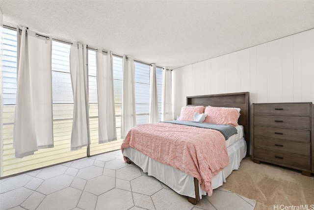 carpeted bedroom with a textured ceiling