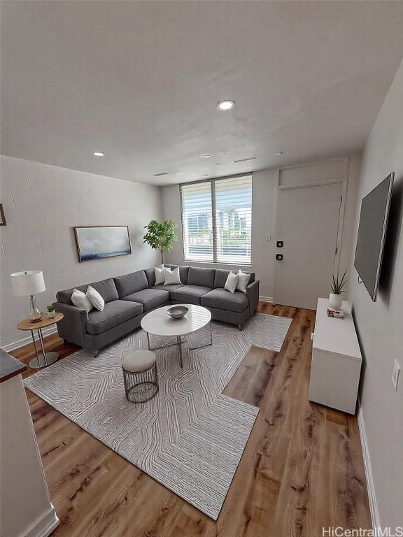 living area with recessed lighting, baseboards, and light wood finished floors