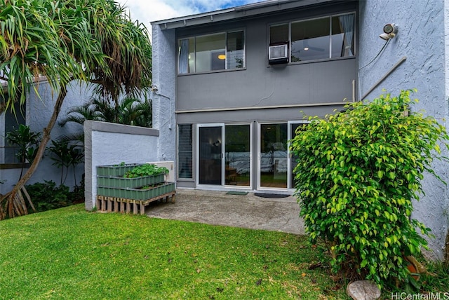 rear view of house with a yard and a patio area