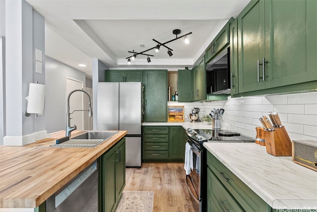 kitchen with sink, green cabinets, and stainless steel appliances