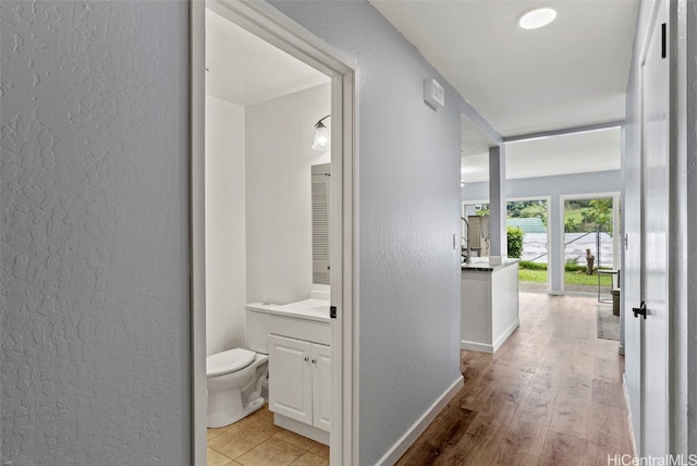 corridor with light hardwood / wood-style floors