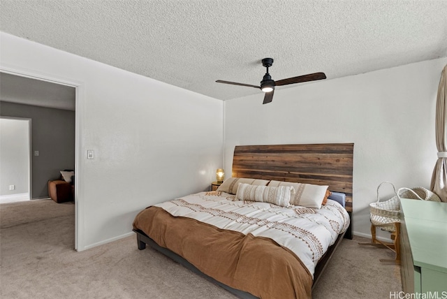 carpeted bedroom featuring a textured ceiling and ceiling fan