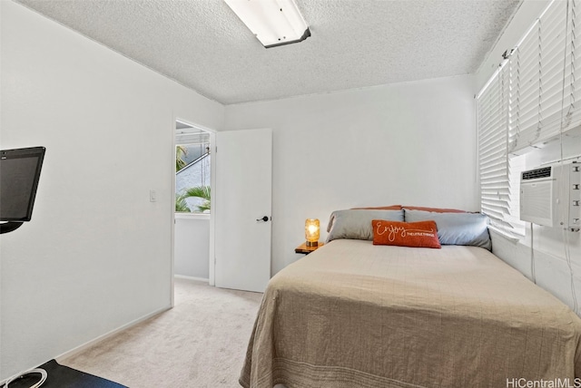 carpeted bedroom featuring cooling unit and a textured ceiling