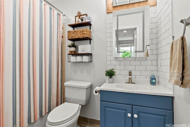 bathroom with toilet, walk in shower, vanity, and decorative backsplash