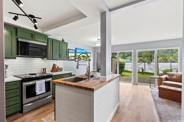 47-228 Hui Akikiki Pl Unit A/701, Kaneohe, HI 96744 - kitchen featuring green cabinets, stainless steel electric range, butcher block countertops, a sink, and light wood finished floors
