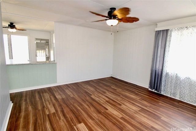 unfurnished room featuring ceiling fan and dark hardwood / wood-style flooring