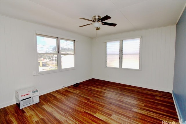 unfurnished room with dark wood-type flooring and ceiling fan