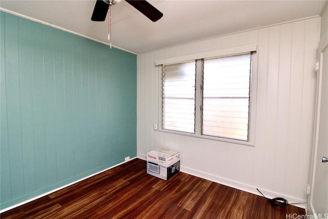 empty room with dark hardwood / wood-style floors and ceiling fan