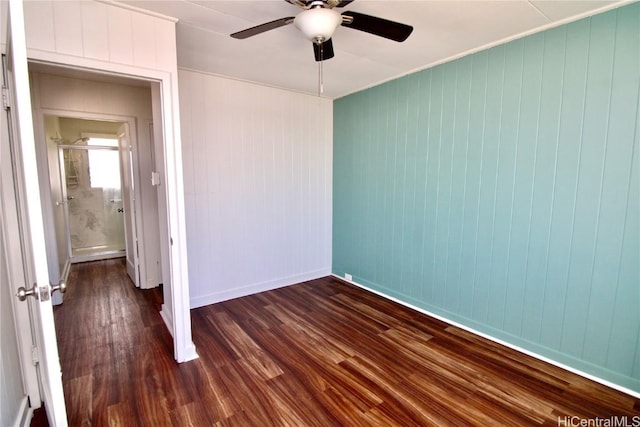 empty room with dark hardwood / wood-style floors and ceiling fan