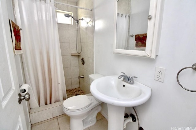 bathroom featuring tile patterned flooring, toilet, and a shower with curtain