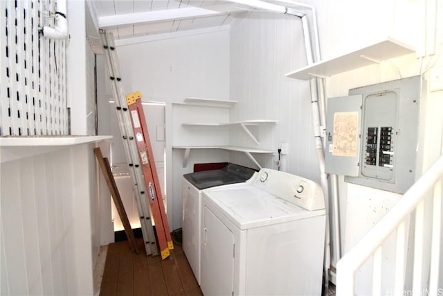 laundry area with wood-type flooring, electric panel, and washing machine and dryer