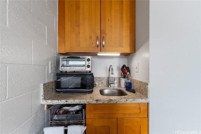 kitchen with sink and light stone counters