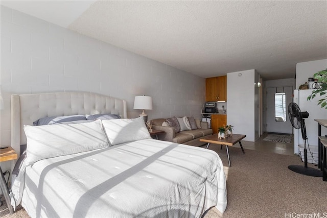 bedroom with white refrigerator and a textured ceiling