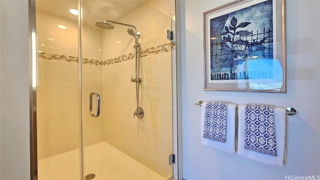 bathroom featuring a shower with door