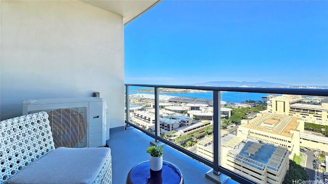 balcony with ac unit and a water and mountain view