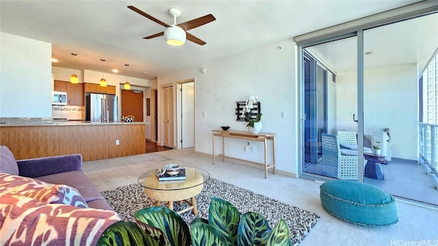 living room with ceiling fan and carpet flooring