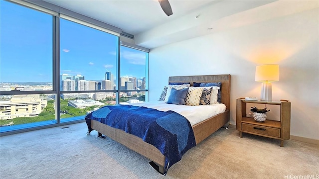 carpeted bedroom with floor to ceiling windows and ceiling fan