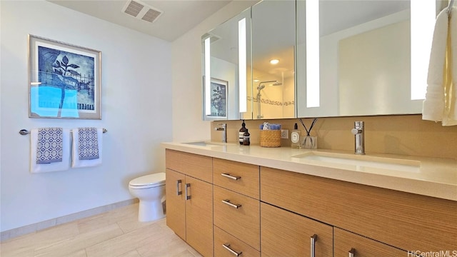 bathroom featuring walk in shower, vanity, and toilet