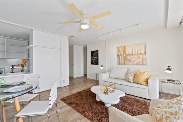 living room featuring wood finished floors, ceiling fan, and track lighting