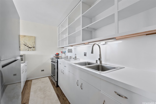 laundry room featuring dark wood-style floors and cabinet space